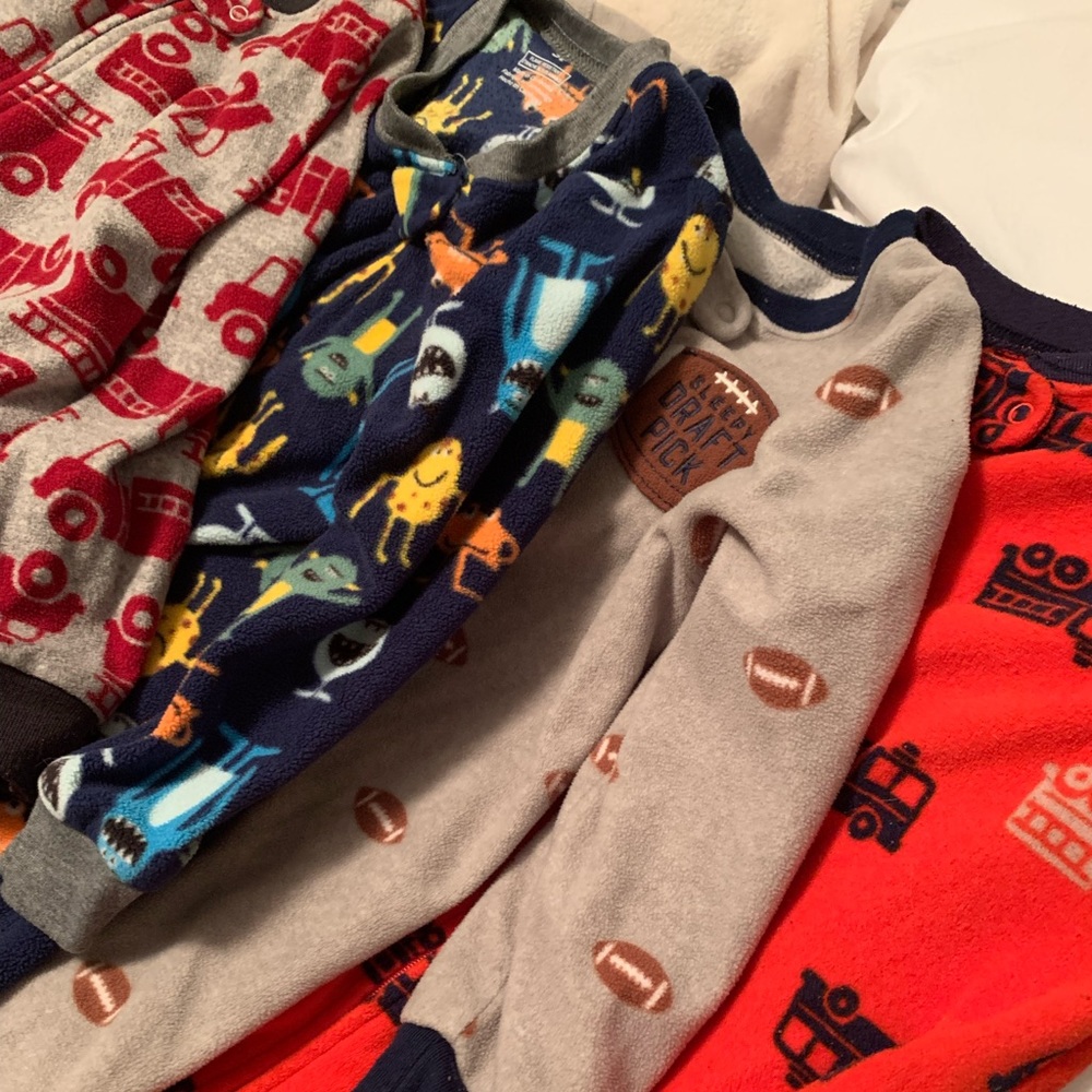 7 sets of one-piece zip footie pjs.
